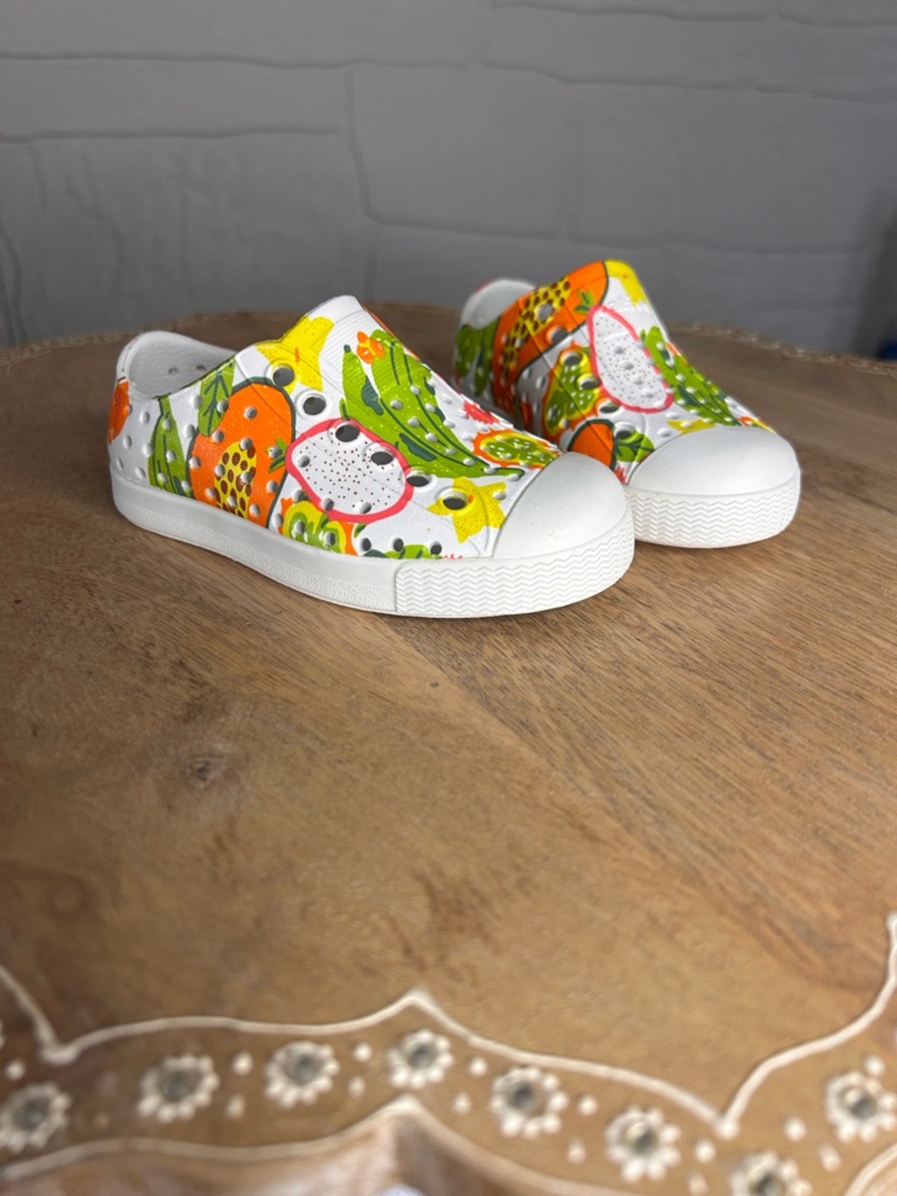 Native Kids Slip-On Water Shoes in White with Orange, Green & Yellow Fruit Print